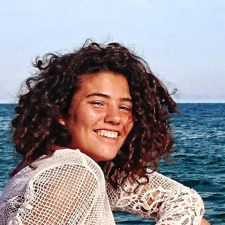 Avery Singh, Lead Design Curator at NetworkArchiveVerdant, reviewing corporate floral arrangements